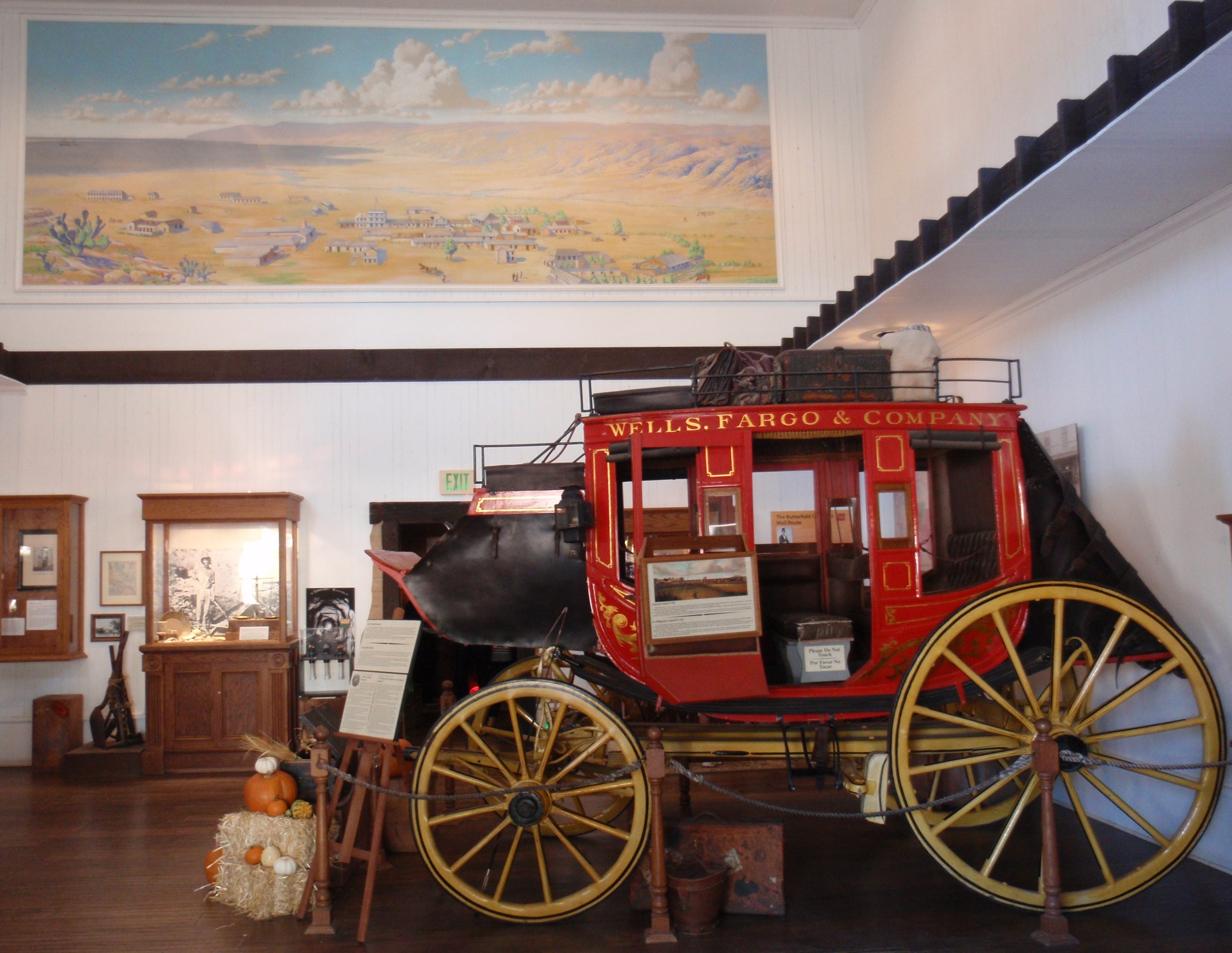 Concord stage coach at Wells Fargo museum in San Diego. Painting at top is of Old Town San Diego in its prime time. Photo by James Ulvog.